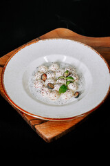 Delicate dessert with creamy texture and garnishes served in a stylish bowl
