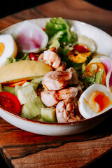 Fresh and colorful salad with shrimp, vegetables, and eggs served in a bowl