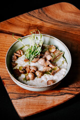 Delicious mushroom dish served in a rustic bowl on a wooden board