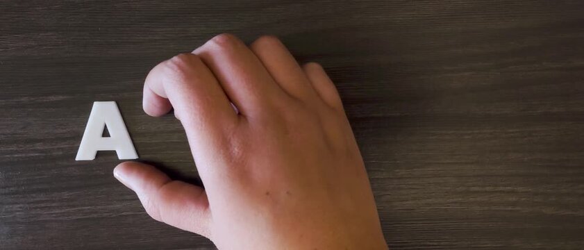 the word autism written on a dark background with white block letters or capital letters