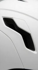Close-up of a white bicycle helmet with a black ventilation slot, showcasing modern design and safety features.