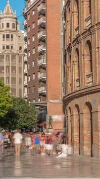 Timelapse of the Bullring of Valencia (Plaza de Bous) and Bullfighting Museum, near Nord station. People walking around the historic amphitheater with a blue sky backdrop. Valencia, Spain.
