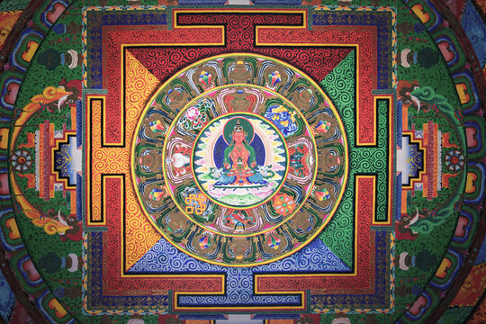 Diqing, China - 19 November 2025: View of the vibrant mandala art, a kaleidoscope of intricate patterns and spiritual symbolism, radiates from the temple ceiling.