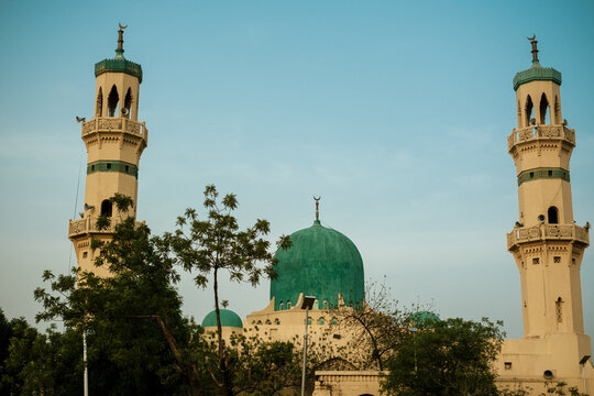 Kano, Nigeria - 26 May 2025: View of the Emir Palace Road mosque, with its striking green dome and towering minarets, stands majestically against the clear sky.