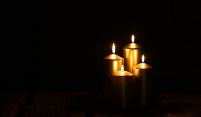 candles burning against holiday lights background