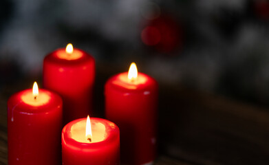 candles burning against holiday lights background