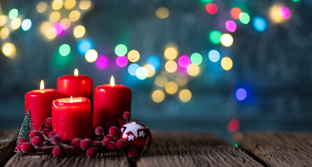 candles burning against holiday lights background