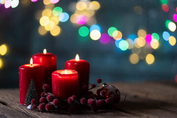 candles burning against holiday lights background