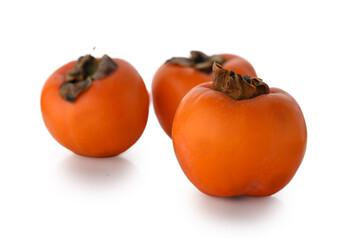 Fresh persimmon trio isolated on white