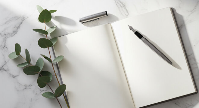 Elegant journaling setup with fountain pen and eucalyptus on marble.
A sophisticated and serene flat lay featuring an open blank journal or notebook and a silver fountain pen