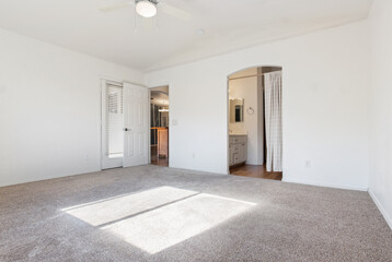 Spacious Bedroom Area with Natural Light and Neutral Decor