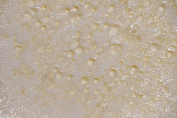 The porous cream layer that forms on top of boiled milk. Fresh, natural, and organic texture. Ideal background for food, beverage, and nutrition-themed projects.