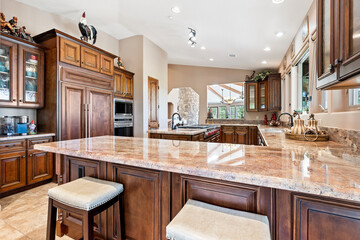 Kitchen with wooden cabinets, granite counters, and stainless steel appliances