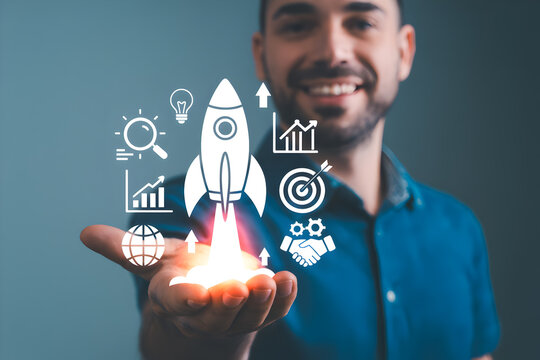 Smiling man presents startup concept with rocket and business icons on his palm symbolizing growth innovation and success in a modern digital world for entrepreneurs and investors