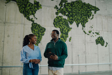 African american colleagues discussing sustainability in green office