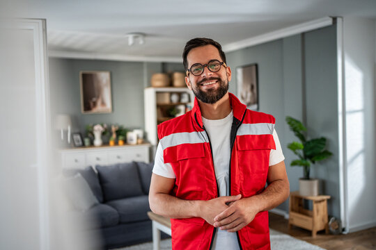 Smiling male paramedic wearing uniform for home visit