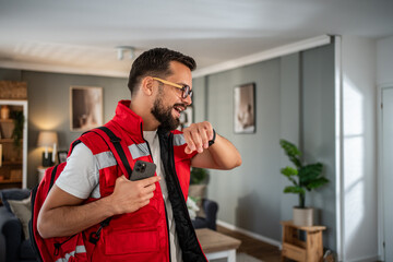 Male paramedic checking time for home visit