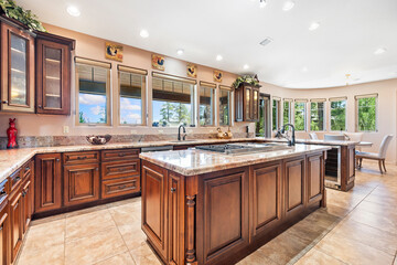 A spacious kitchen with beautiful wooden cabinets and granite countertops