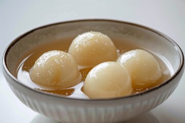 Delicious sweet dumplings in syrup served in a bowl