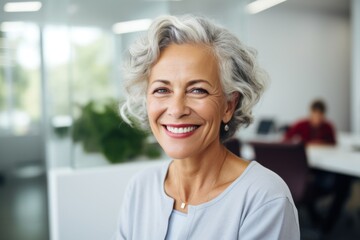 Senior woman smiling in a modern office environment