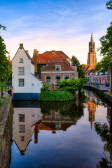 Naklejka premium Evening Shot from Beautiful Amersfoort, Netherlands, with the Canal that Surrounds and Divides the Historic City Center, and the Onze Lieve Vrouwetoren Tower