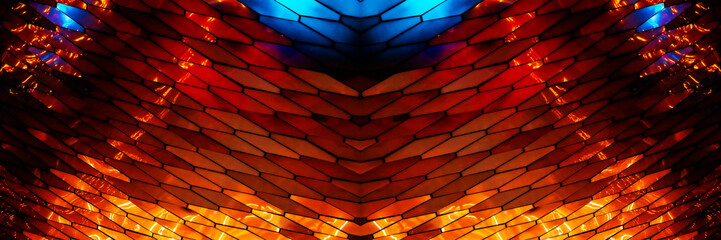 abstract, geometric wall made of hexagonal, glass-like tiles. The tiles reflect colorful lights creating a vibrant, shimmering effect. The overall texture is sleek and modern, almost cosmic aesthetic