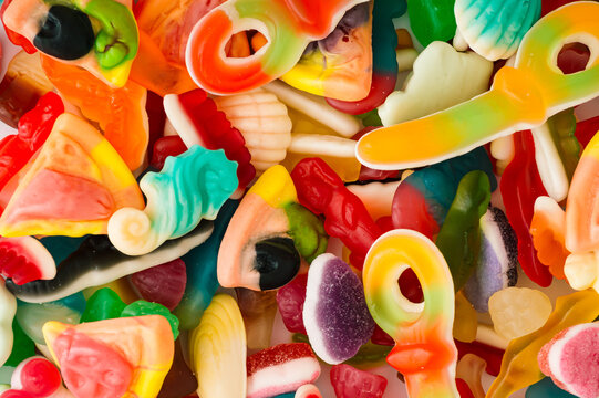 Creative background made of gummy candies. Minimal trendy gummies concept. Jelly sweets aesthetic. Colorful flat lay. Top view.