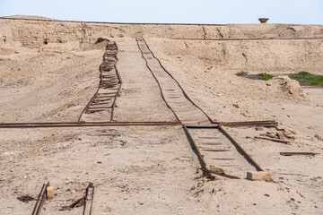 Train tracks which were used for excavations, railway tracks stretch into a barren landscape in Uruk, Iraq
