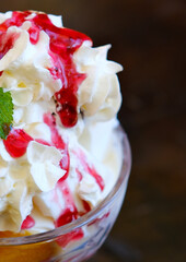 Delicious cupcakes with cream and cherries on light textured table. High quality photo