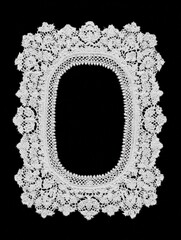 Ornate rectangular lace frame with open center on black background