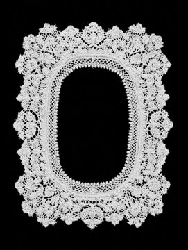 Ornate rectangular lace frame with open center on black background