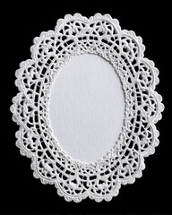 Oval white lace doily with open center on black background