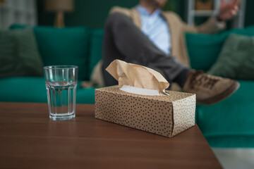 Person attending counseling session with tissues and water