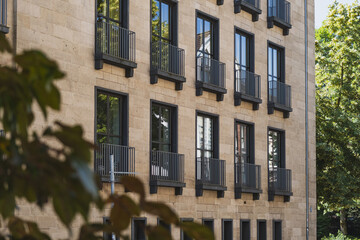Fototapeta premium Modern building facade with small balconies and large windows
