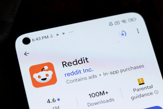 Warsaw, Poland - November 20, 2025: A close-up view of a smartphone screen displaying the Reddit app, featuring its logo and rating, conveying digital communication.