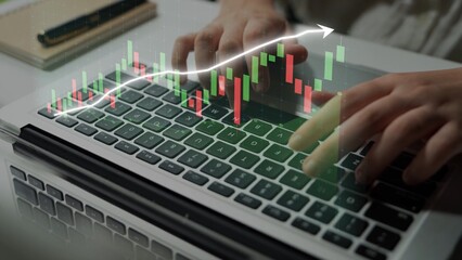 A focused view of hands typing on a laptop keyboard, with a stock market graph overlay depicting financial data trends in a modern business environment. Copula