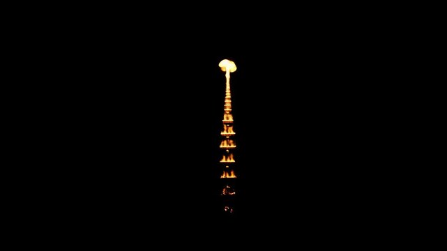Glowing lights are reflected on a dark surface, showing a vertical row of illuminated objects creating a visually stunning, symmetrical composition, with a focus on the interplay between light and...