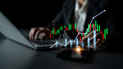 A business professional analyzes financial charts on a laptop in a dark office. The image features stock market data graphics, reflecting investment strategies and growth trends. Scalp