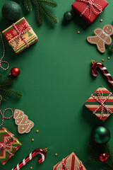 Festive vertical scene with wrapped gifts, candy canes, gingerbread cookies, and pine branches on a...