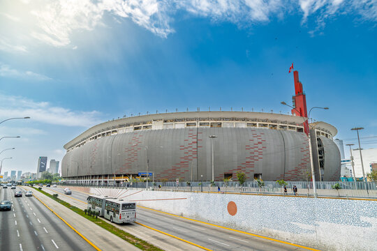 Lima, Peru &ndash; January 14, 2024: View of the National Stadium with curved facade, red accents and surrounding urban traffic