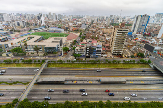 Lima, Peru &ndash; January 14, 2024: Aerial view of highway and urban layout in Lince district with sports field and pedestrian bridges