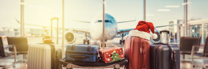 Luggage with Christmas decorations at airport terminal for holiday travel