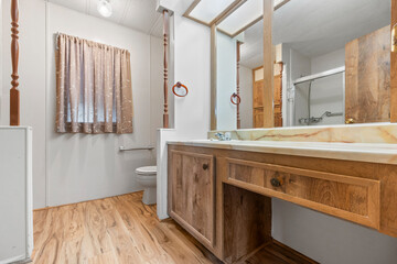 A wellequipped bathroom featuring a sink, toilet, and a mirror