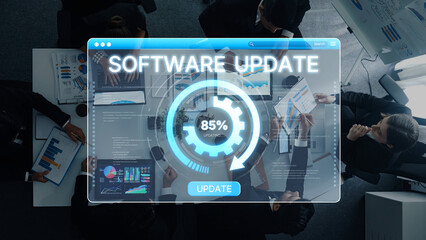 Fototapeta premium A high-tech meeting scene showing professionals collaborating on a software update. Digital interface displays analytics and progress, highlighting teamwork and innovation. Trope