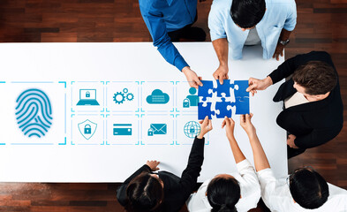 A diverse group of professionals collaborates at a modern office, engaging in a brainstorming session. They work on a puzzle symbolizing teamwork and security. Trope