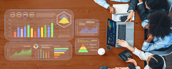 A group of professionals collaborating over data analysis, surrounded by graphs and charts, reflecting teamwork in a modern office setting. A seamless blend of technology and strategy. Trope