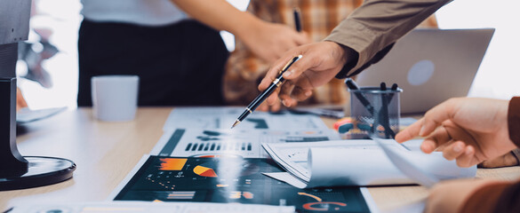 A dynamic office scene showcasing professionals engaged in a collaborative meeting, analyzing data and strategizing, reflecting teamwork and innovation in modern workplaces. SACTR