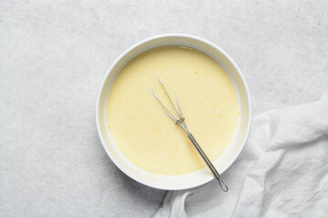 Overhead view of custard for making bread pudding, process of making bread pudding