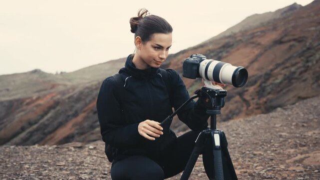 Photographer hiking and capturing nature landscapes with a camera. Concept tourism and outdoor adventure