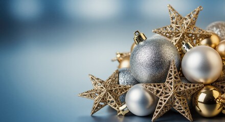 A collection of silver and gold Christmas decorations. Festive stars and baubles on a blue background. Holiday celebration concept with copy space